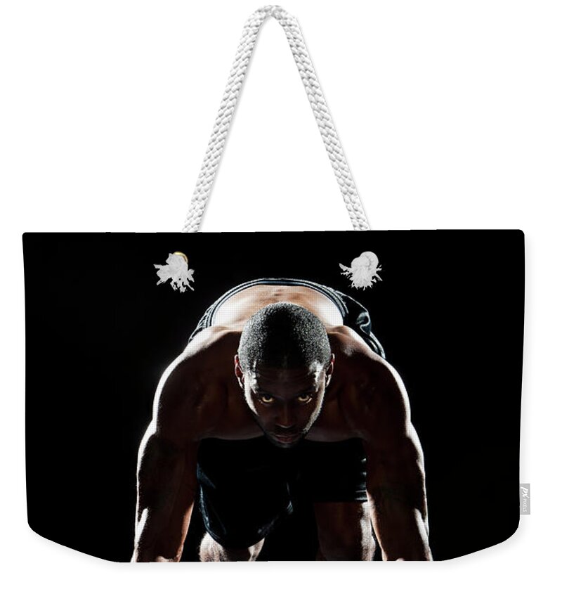 Focus Weekender Tote Bag featuring the photograph Male Sprinter In Starting Position by Matt Henry Gunther