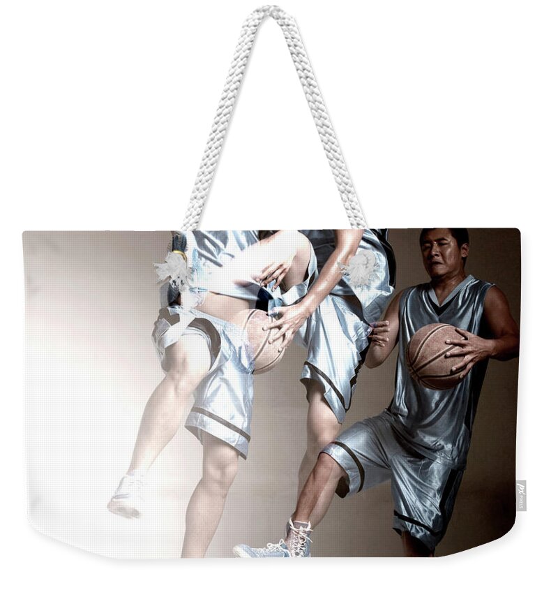 People Weekender Tote Bag featuring the photograph Man Playing Basketball by Ting Hoo