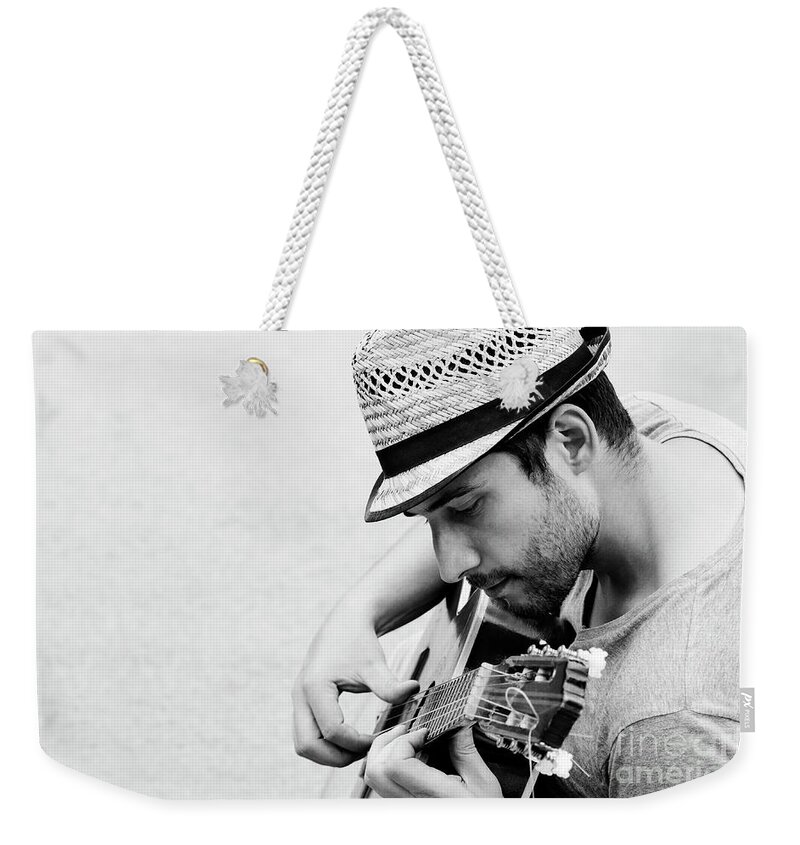 Guitar Weekender Tote Bag featuring the photograph Man plays the guitar by Jelena Jovanovic