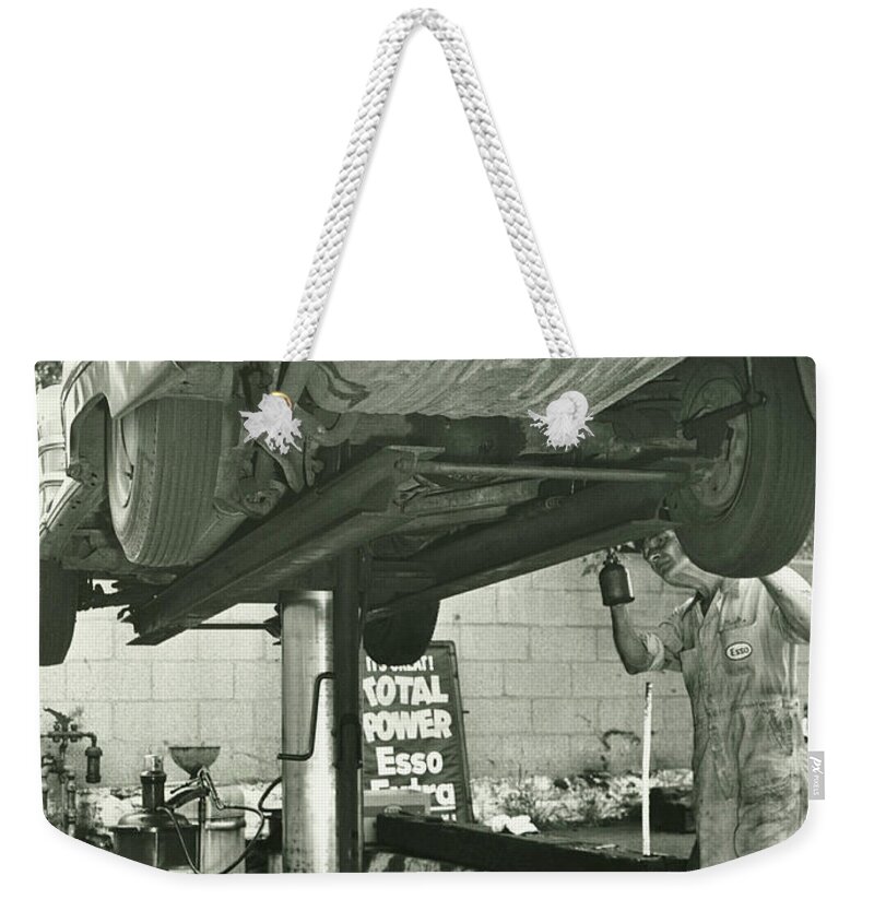 One Man Only Weekender Tote Bag featuring the photograph Man Repairing Uplifted Car, B&w, Low by George Marks
