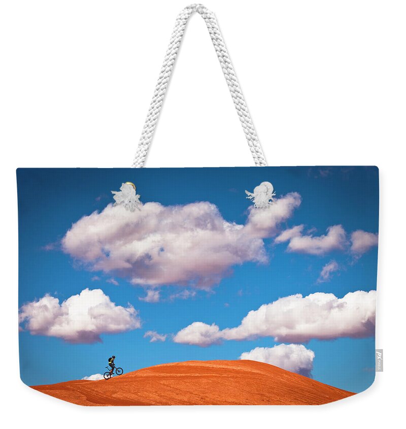 Slickrock Trail Weekender Tote Bag featuring the photograph Mountain Biker Climbing On Slick Rock by Visualcommunications