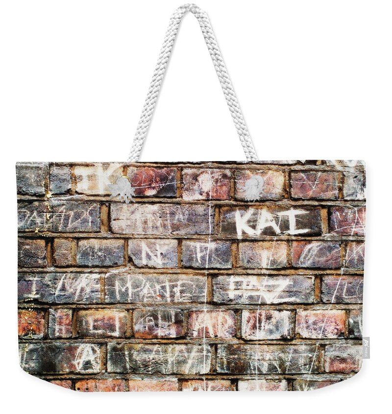 Art Weekender Tote Bag featuring the photograph Names On A Brickwall, Handwritten Like by Marcoventuriniautieri