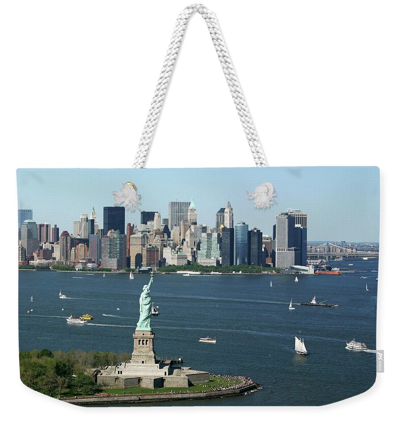 Lower Manhattan Weekender Tote Bag featuring the photograph New York Harbor And Skyline by Terraxplorer