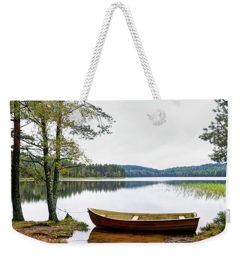 Tranquility Weekender Tote Bag featuring the photograph Nordic Skiff Eka Moored By A Quiet Lake by Johan Klovsjö