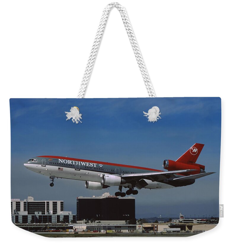Northwest Airlines Weekender Tote Bag featuring the photograph Northwest Airlines DC-10-40 Landing at Los Angeles by Erik Simonsen