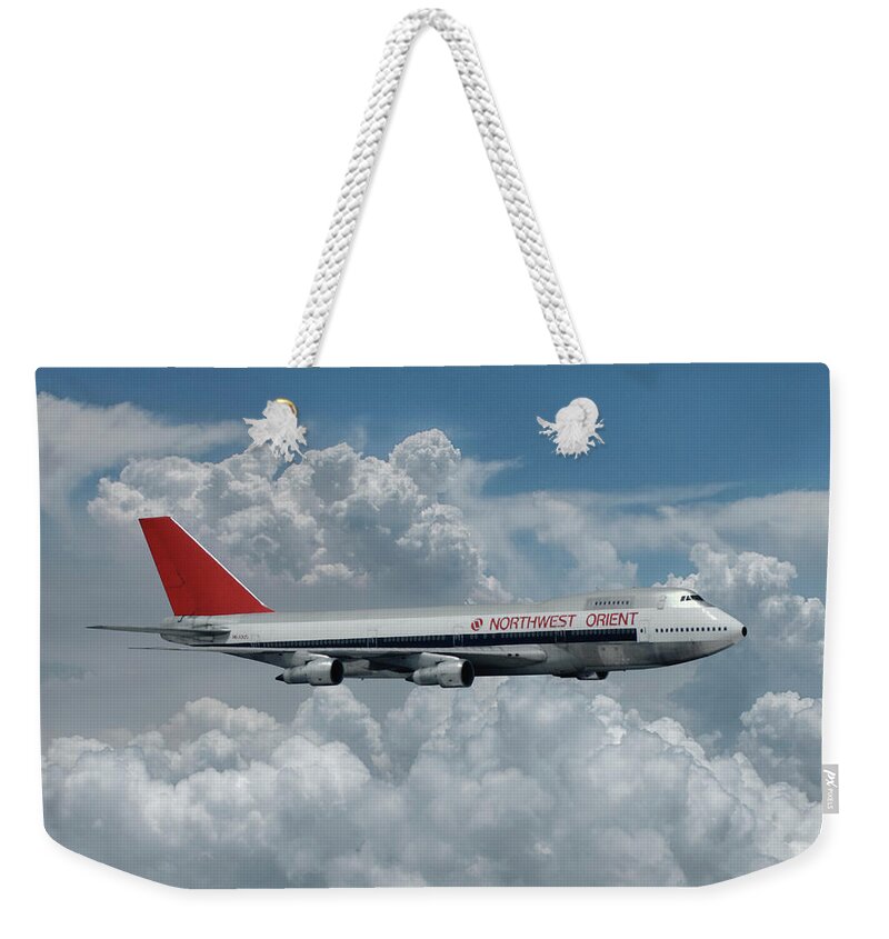 Northwest Orient Airlines Weekender Tote Bag featuring the mixed media Northwest Orient Among the Clouds by Erik Simonsen