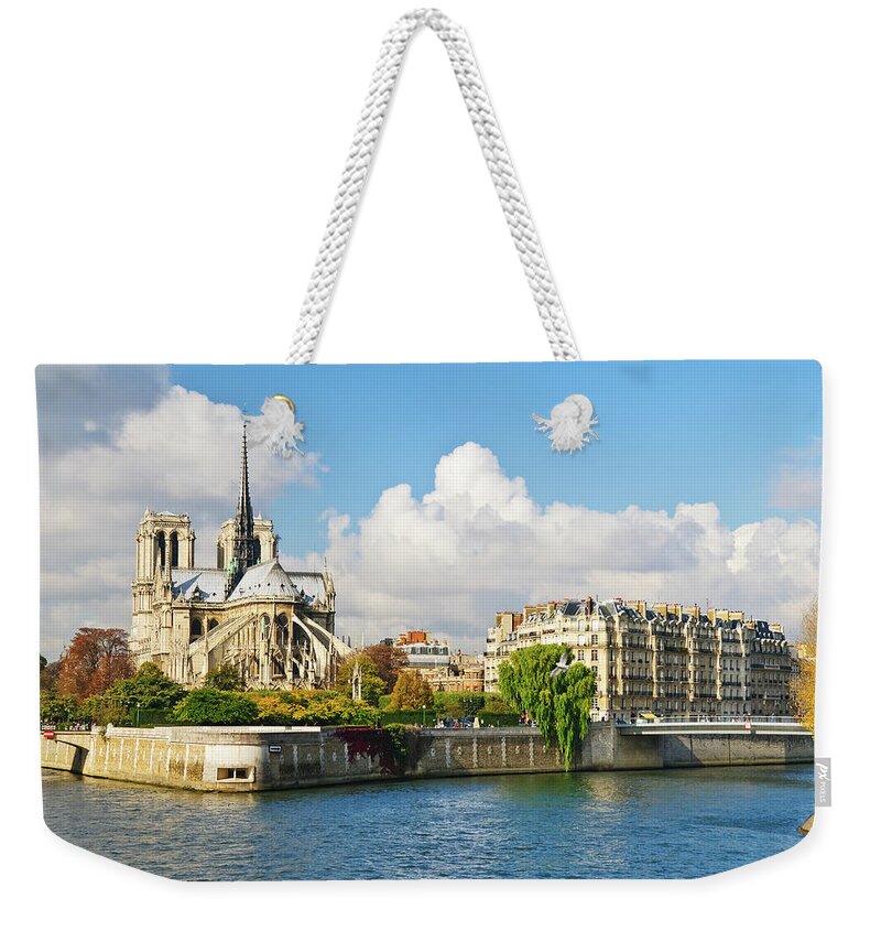 Old Town Weekender Tote Bag featuring the photograph Notre Dame Cathedral And Isle De La Cite by Tom Bonaventure