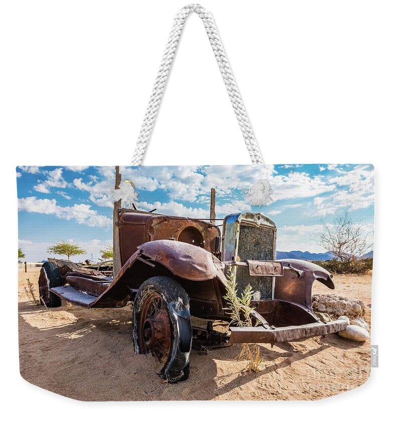 Car Weekender Tote Bag featuring the photograph Old and abandoned car #3 in Solitaire, Namibia by Lyl Dil Creations