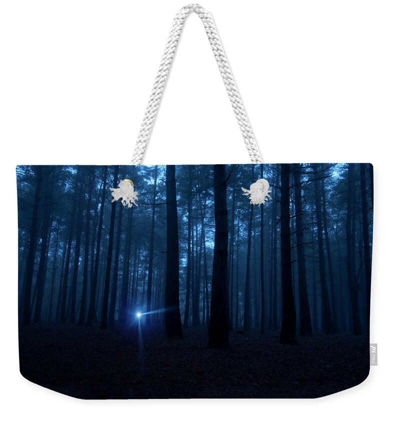 Shadow Weekender Tote Bag featuring the photograph One Light In The Dark Spooky Woods At by Nkbimages