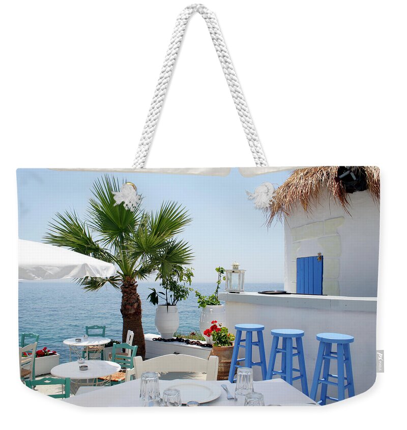 Greek Culture Weekender Tote Bag featuring the photograph Open Air Restaurant By The Sea In by Alanphillips