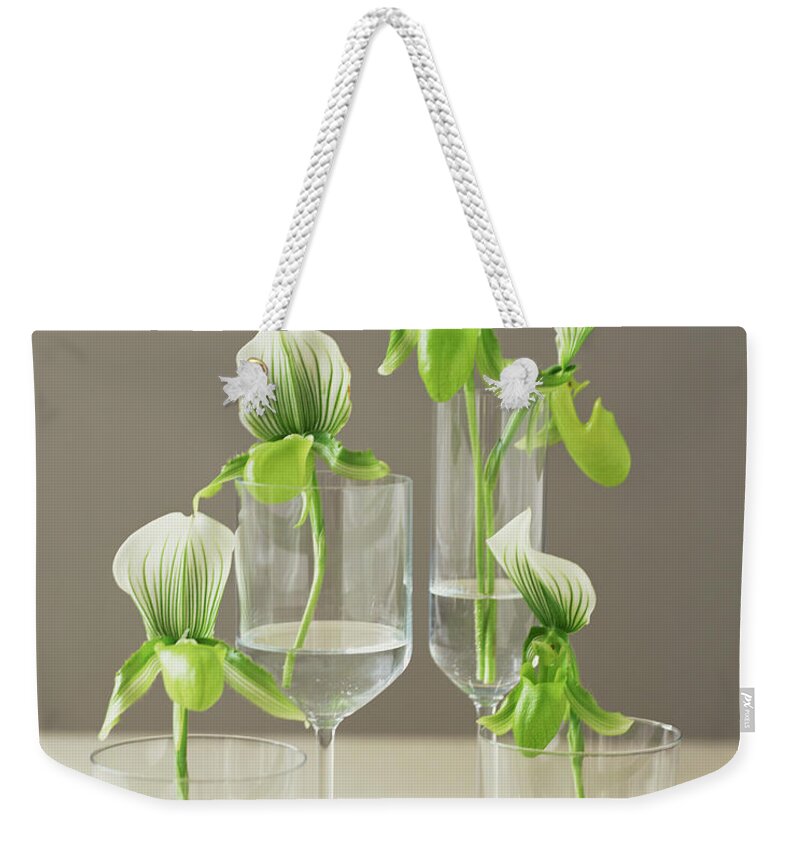 Bouquet Weekender Tote Bag featuring the photograph Orchids In Glasses by Lisa Hubbard