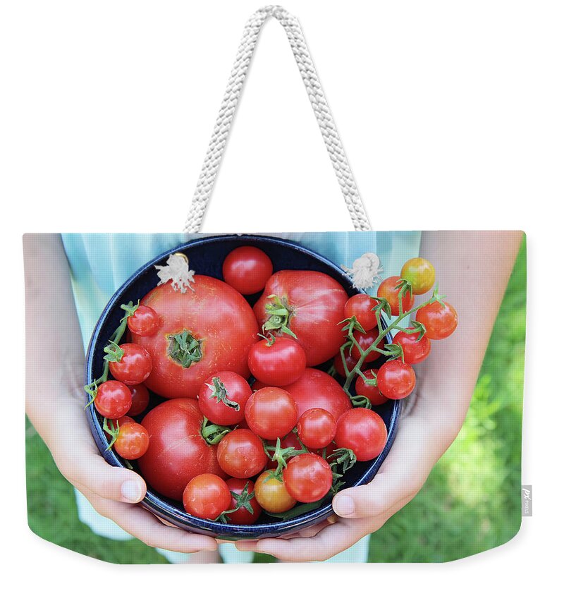 Grass Weekender Tote Bag featuring the photograph Organic Home Grown Tomatoes Held By Girl by Dianne Avery Photography