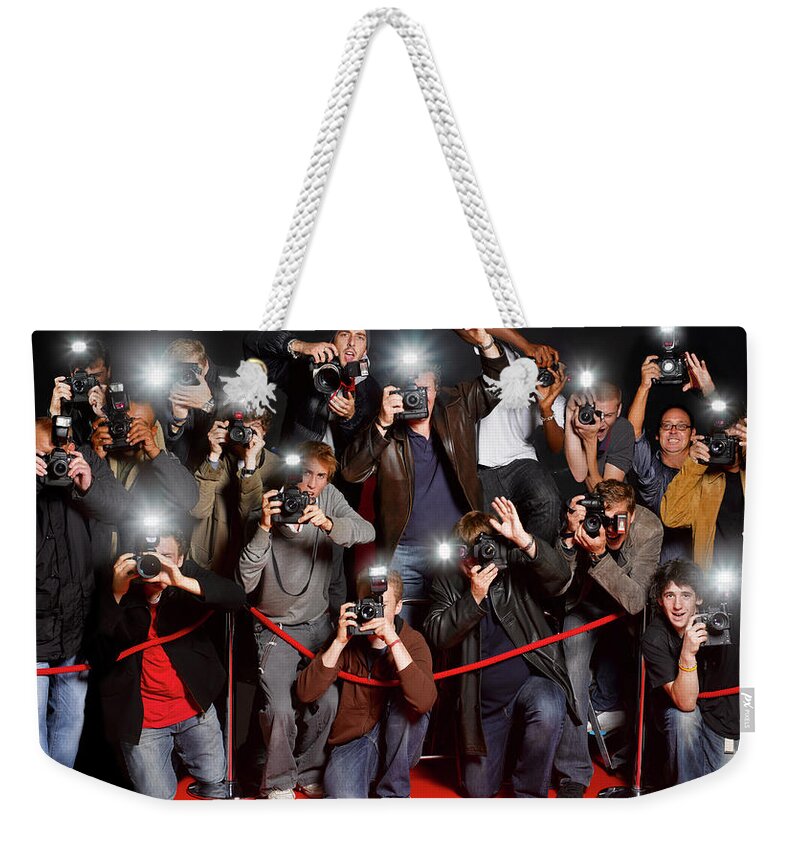People Weekender Tote Bag featuring the photograph Paparazzi Behind Cordon At Premiere by Peter Dazeley