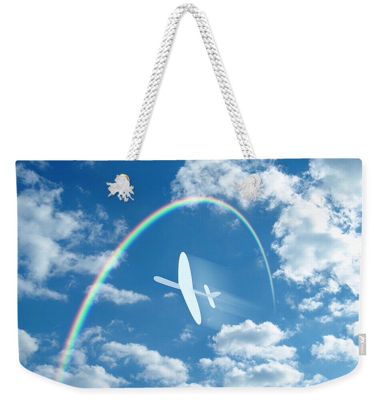 Outdoors Weekender Tote Bag featuring the photograph Paper Airplane Flying Through A Blue by Gyro Photography/amanaimagesrf