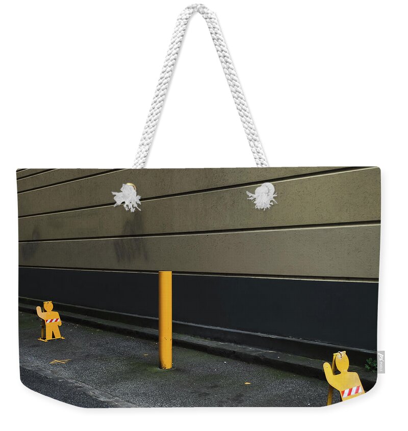 Tranquility Weekender Tote Bag featuring the photograph Parking Guards Humanoid by John Abbate