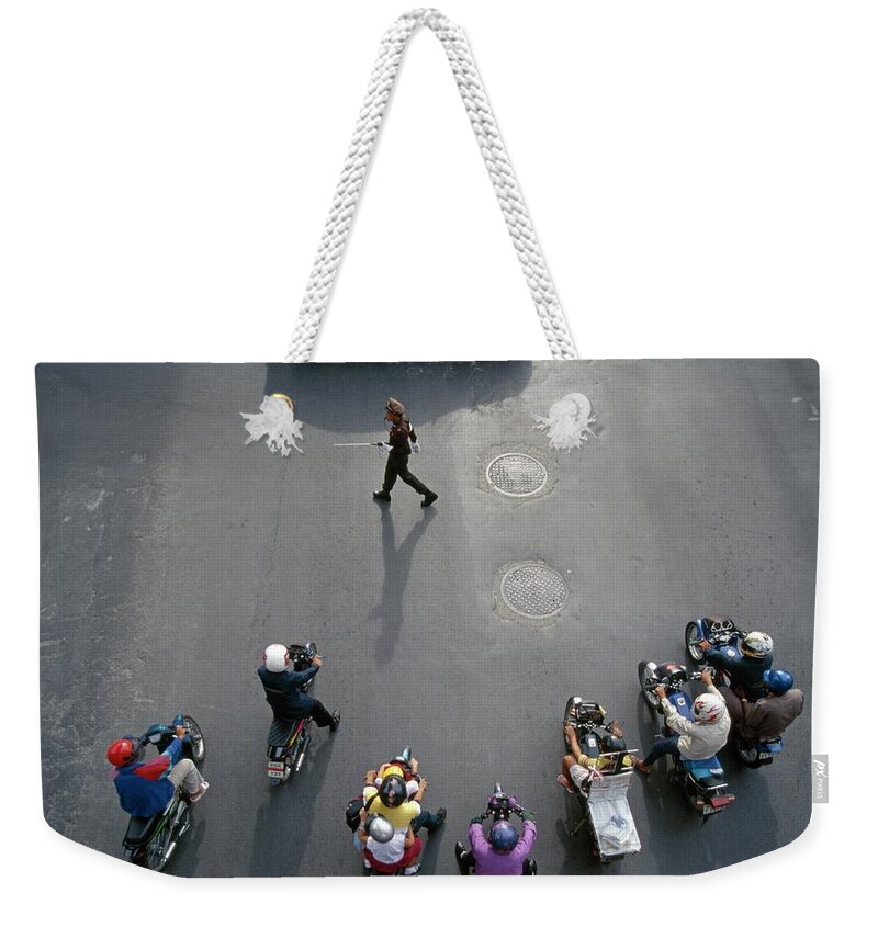 Crash Helmet Weekender Tote Bag featuring the photograph People Riding Motor Scooters On City by Marc Volk