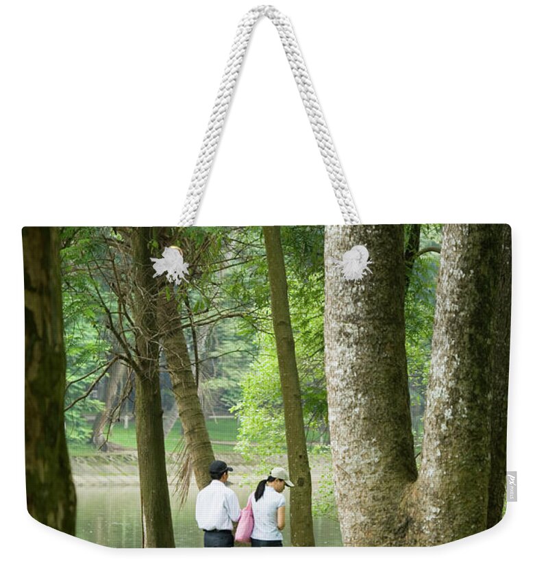 Tranquility Weekender Tote Bag featuring the photograph People Walking In Botanic Gardens by Lonely Planet