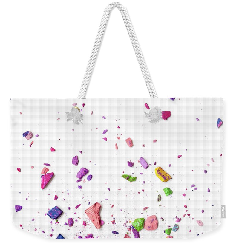 White Background Weekender Tote Bag featuring the photograph Pieces Of Various Crushed Up Make-up by Larry Washburn