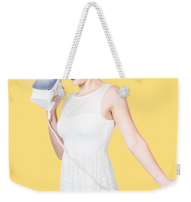 Cleaning Weekender Tote Bag featuring the photograph Pin up woman providing steam clean ironing service by Jorgo Photography
