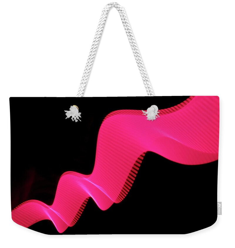 Laser Weekender Tote Bag featuring the photograph Pink Abstract Coloured Lights Trails by John Rensten
