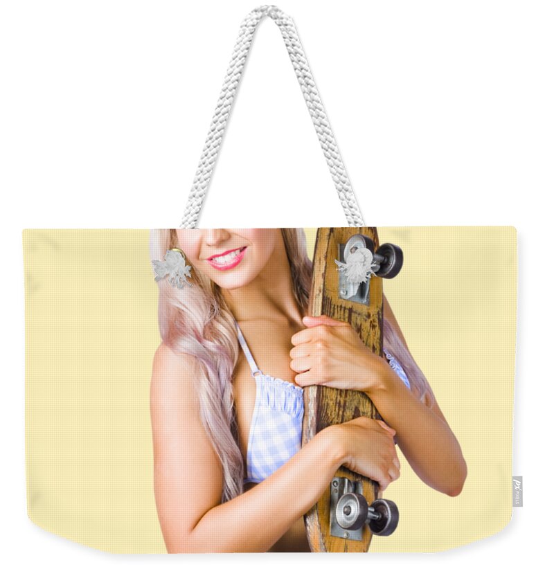 Skate Weekender Tote Bag featuring the photograph Pinup woman in bikini holding skateboard by Jorgo Photography