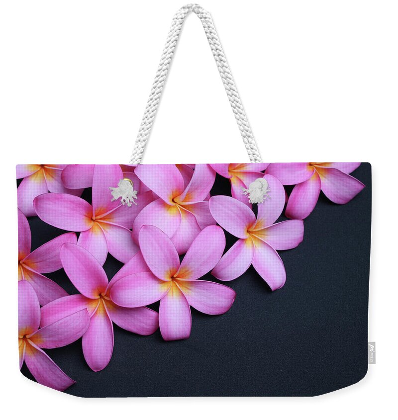 Single Flower Weekender Tote Bag featuring the photograph Plumeria On Black by Focalhelicopter