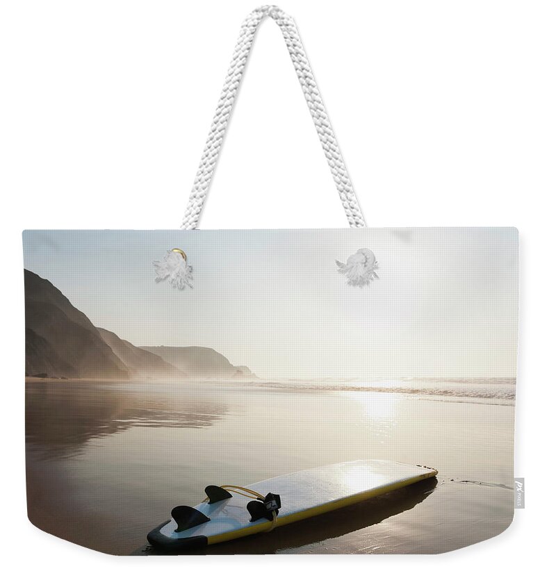 Algarve Weekender Tote Bag featuring the photograph Portugal, Surfboard On Beach by Westend61