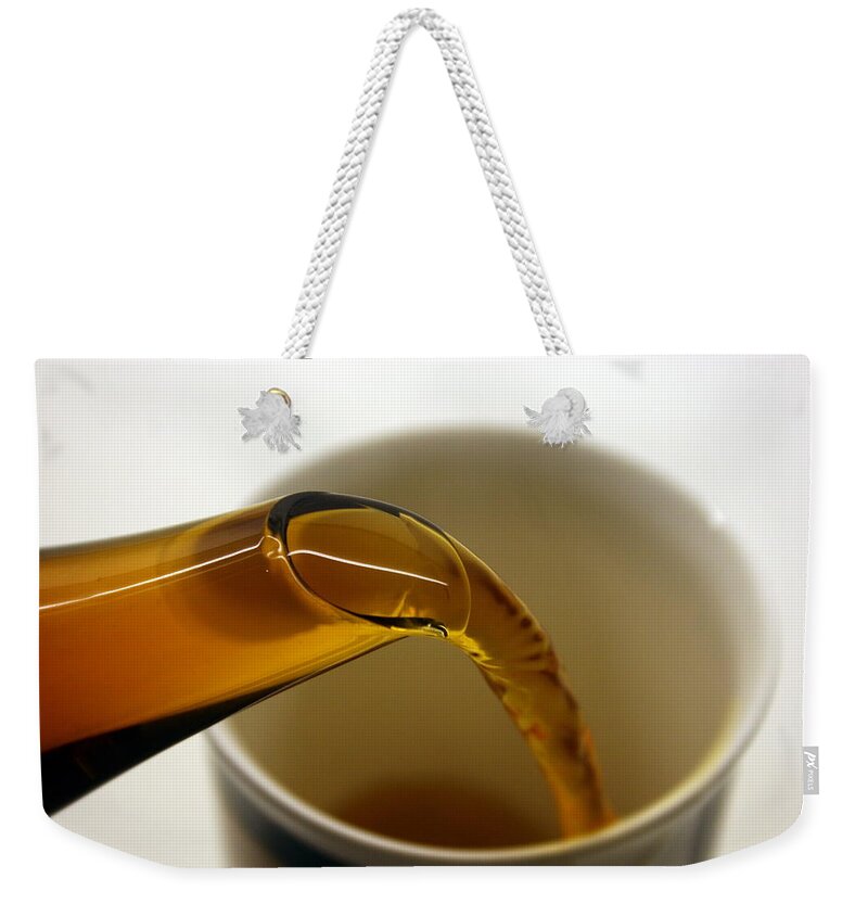 White Background Weekender Tote Bag featuring the photograph Pouring Tea by Bob Balmer Images