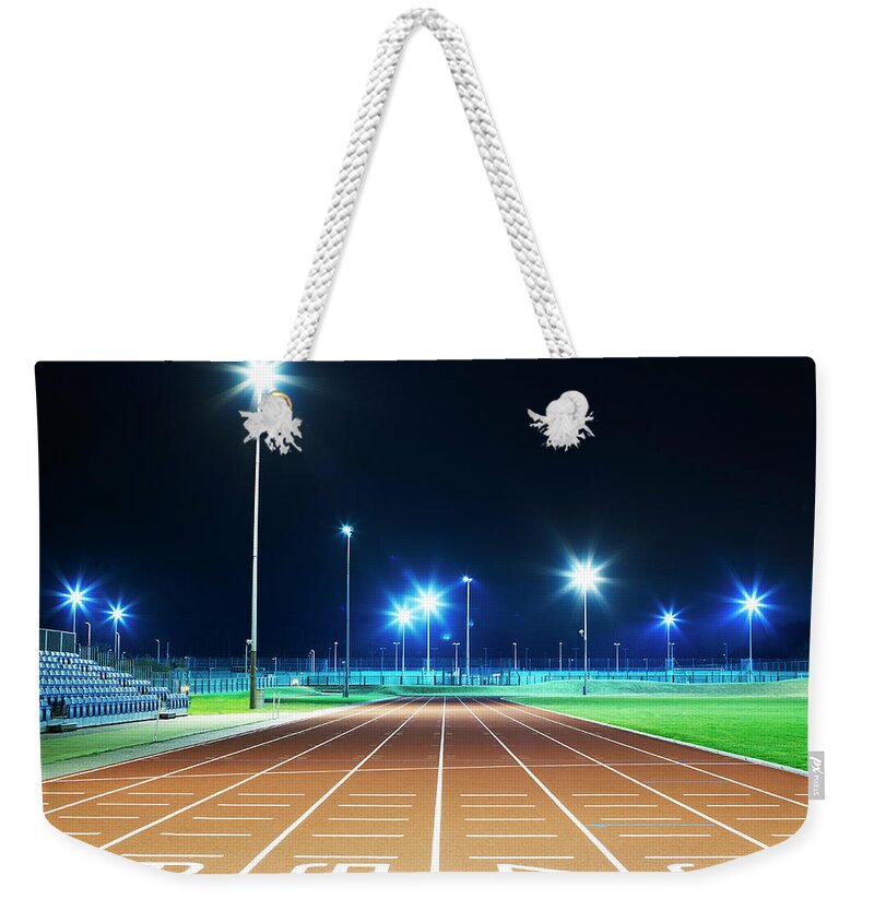 Performance Weekender Tote Bag featuring the photograph Race Track At Night by Mike Harrington