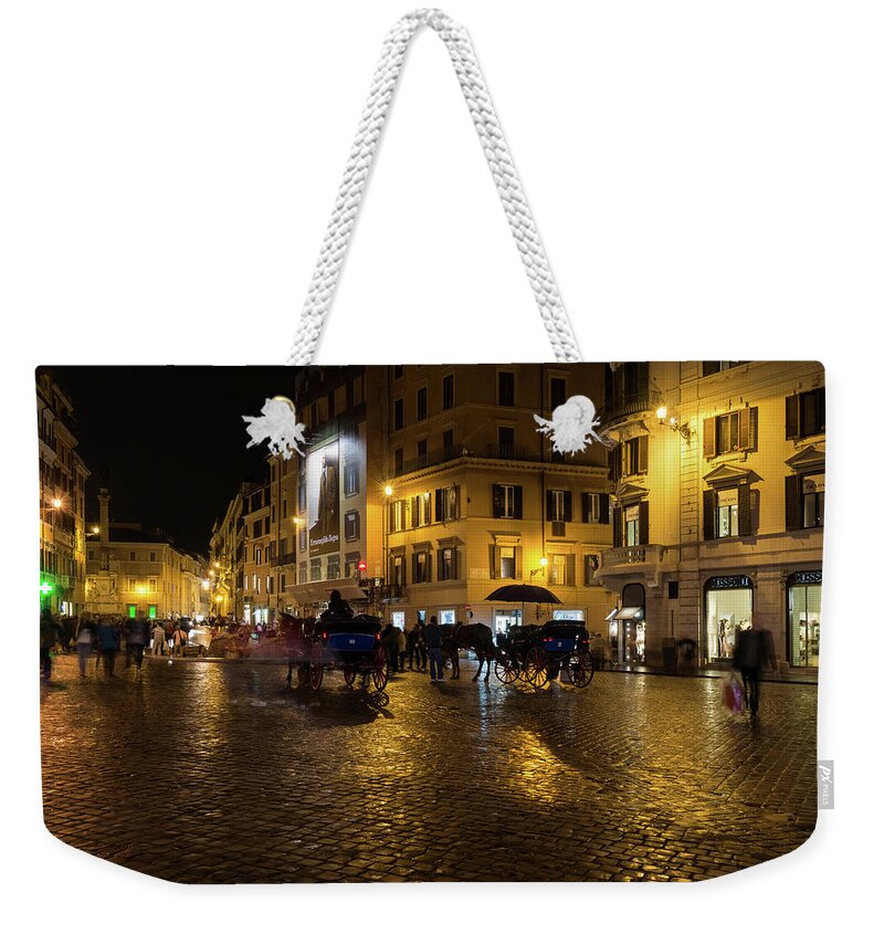 Georgia Mizuleva Weekender Tote Bag featuring the photograph Rainy Rome - Slo Mo Shoppers Horses and Carriages on Glowing Piazza di Spagna by Georgia Mizuleva