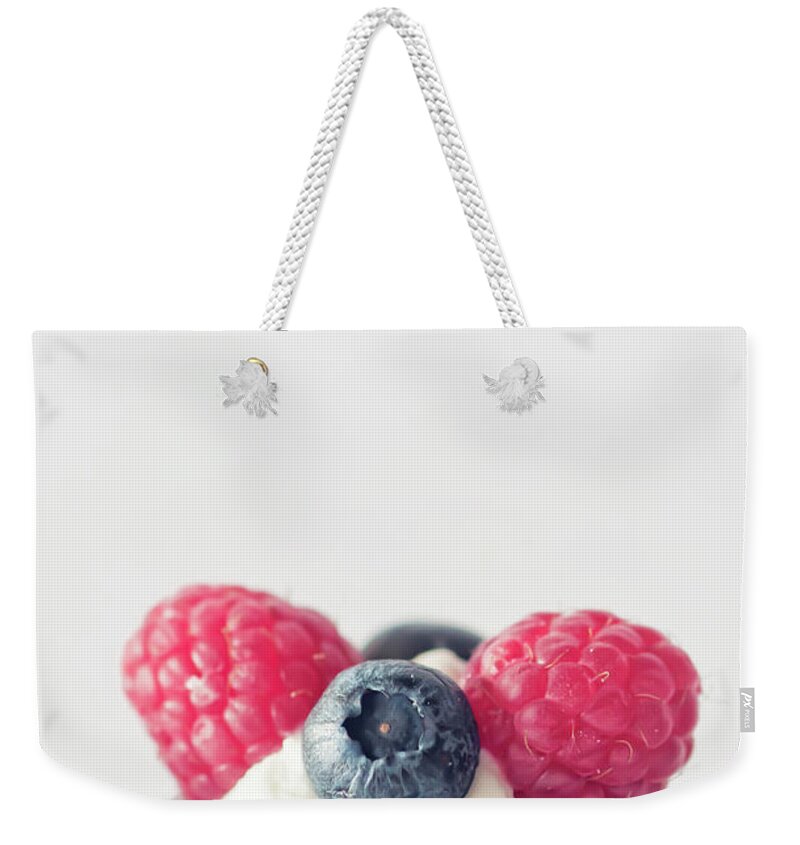 Unhealthy Eating Weekender Tote Bag featuring the photograph Raspberries And Blueberries Cupcake by Marta Nardini