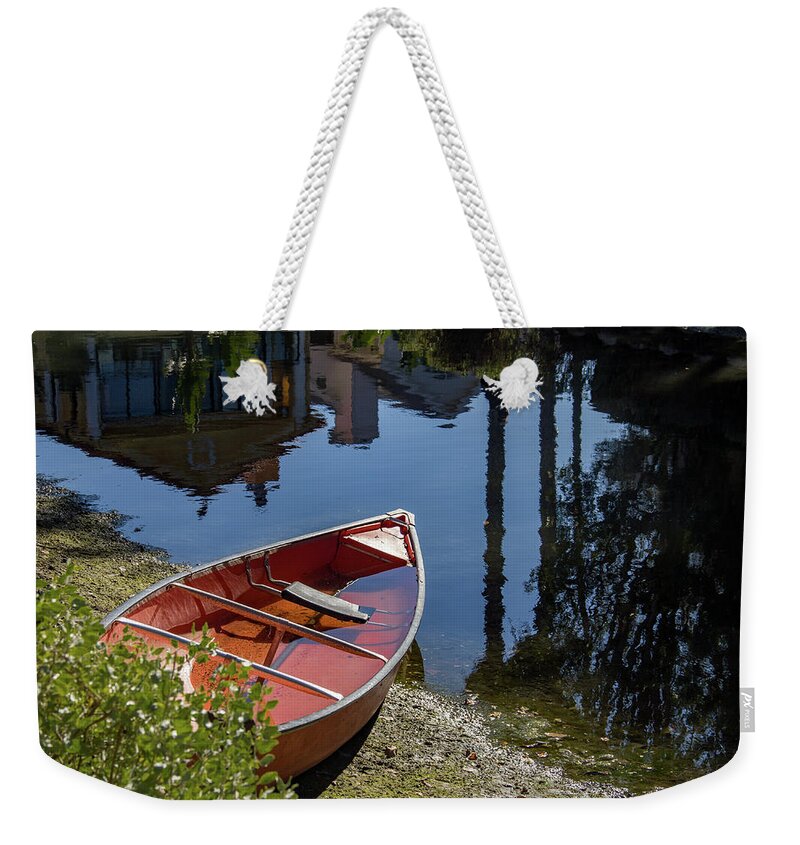 Beached Weekender Tote Bag featuring the photograph Red Boat on Canal Shore by Roslyn Wilkins