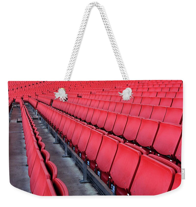 Aisle Weekender Tote Bag featuring the photograph Red Empty Chairs In A Stadium by Jonathan Kitchen