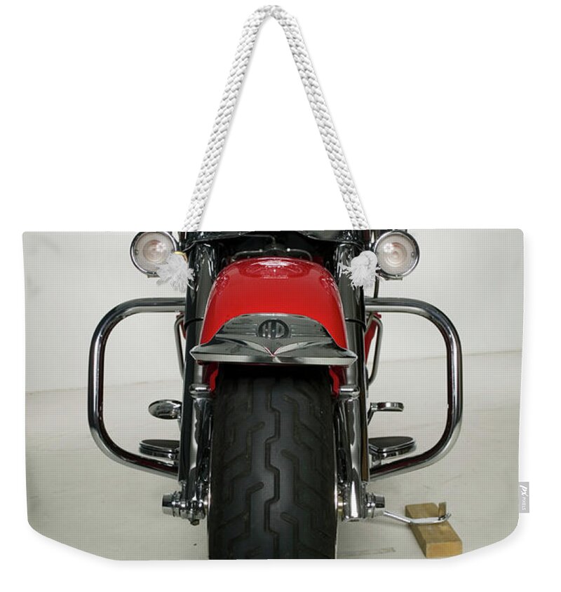 Handlebar Weekender Tote Bag featuring the photograph Red Motorcycle Parked In Studio by Photodisc