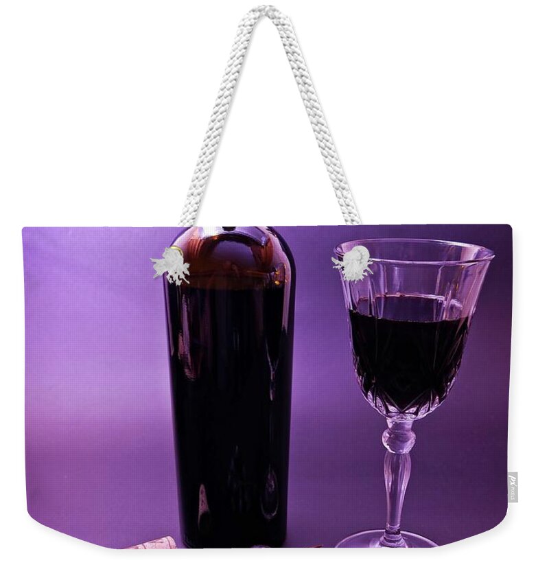 Red Weekender Tote Bag featuring the photograph Red wine display by Martin Smith