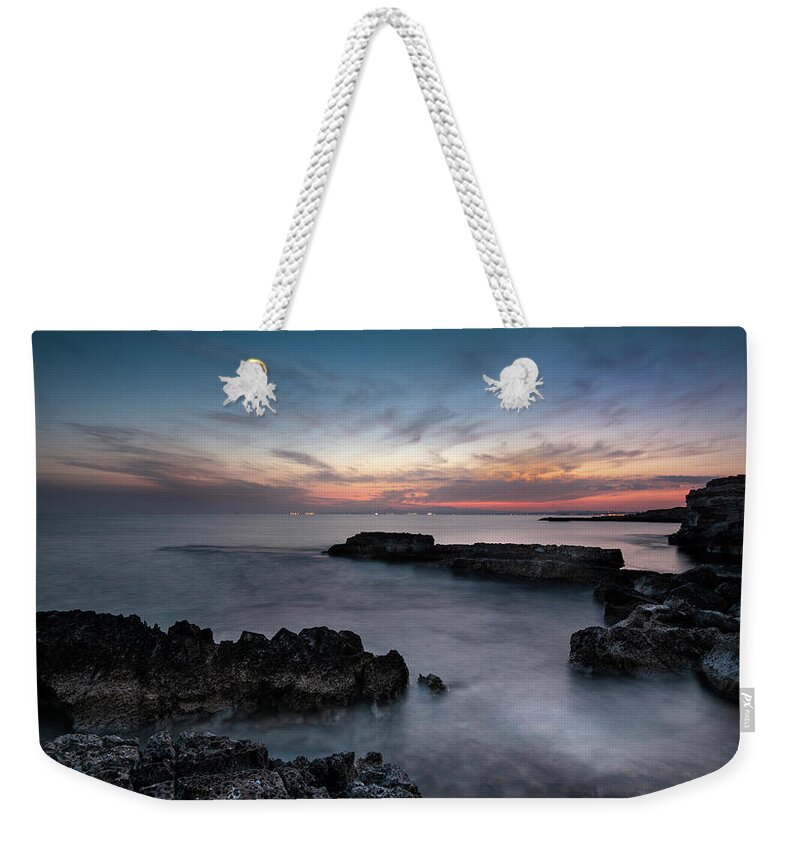 Seascape Weekender Tote Bag featuring the photograph Rocky Seascape with dramatic beautiful sunset by Michalakis Ppalis