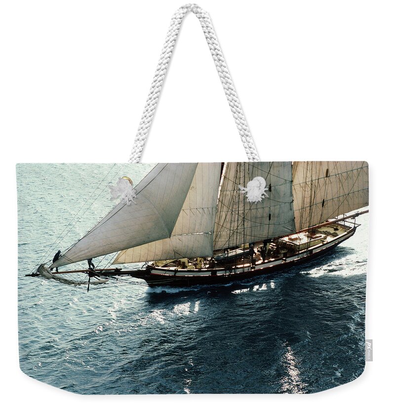 Baltimore Weekender Tote Bag featuring the photograph Sailing Boat At Sea, Sunrise, Aerial by Greg Pease