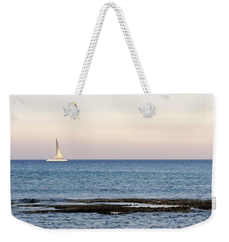 Sea Weekender Tote Bag featuring the photograph Sailing boat in the Calm Ocean by Michalakis Ppalis