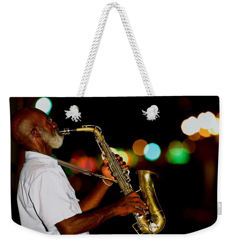 One Man Only Weekender Tote Bag featuring the photograph Saxophonist On Street At Night, New by Siegfried Layda