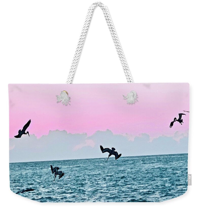 Birds Weekender Tote Bag featuring the photograph Seagulls Diving for Dinner at Sunset in Captiva Island Florida by Shelly Tschupp