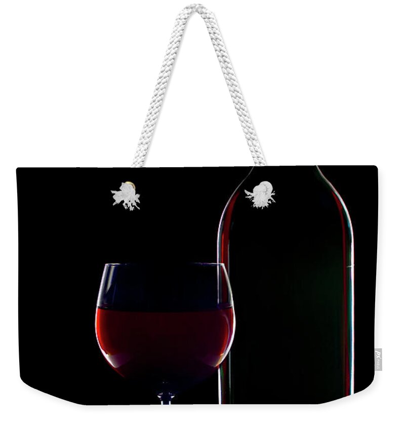 Black Color Weekender Tote Bag featuring the photograph Silhouette Of Red Wine Bottle And Glas by Lightpix