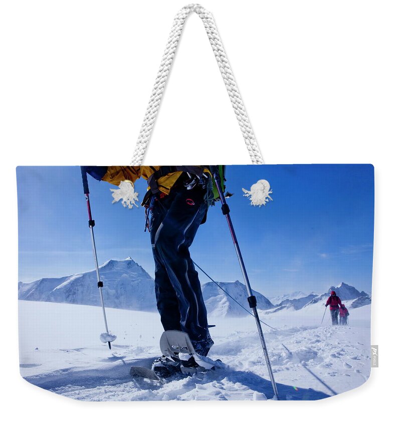 Estock Weekender Tote Bag featuring the digital art Snowshoeing On Mountain by Christof Sonderegger