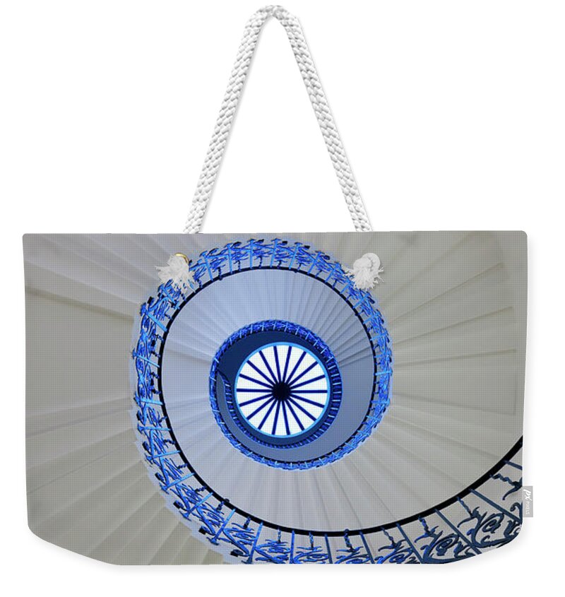 Directly Below Weekender Tote Bag featuring the photograph Spiral Staircase by Peter Adams