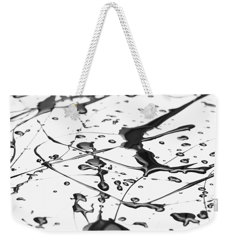 Curve Weekender Tote Bag featuring the photograph Splattered Black Paint Making A Complex by Ralf Hiemisch