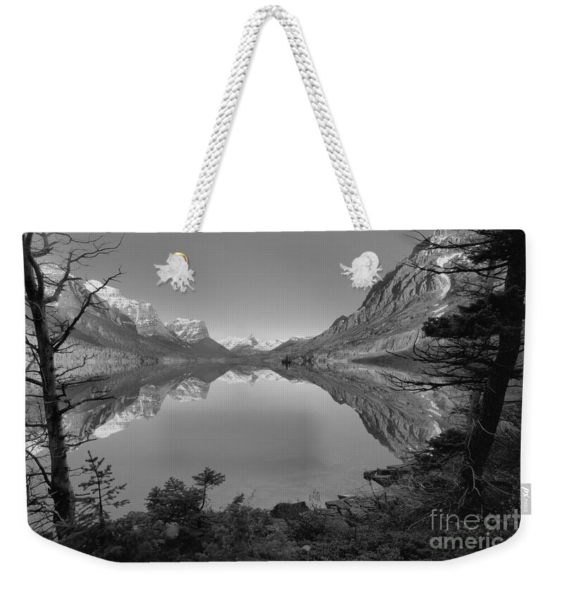 St Mary Weekender Tote Bag featuring the photograph St. Mary Sunrise Through The Trees Black And White by Adam Jewell