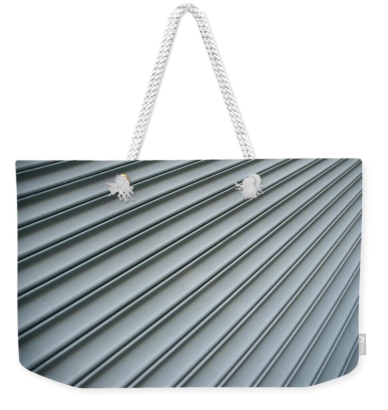 Metalwork Weekender Tote Bag featuring the photograph Steel Shutter Lines Background Diagonal by Peskymonkey