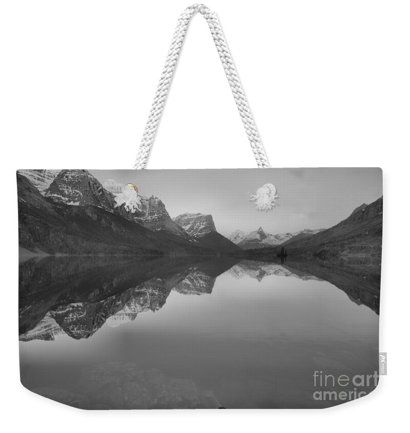 St Mary Weekender Tote Bag featuring the photograph Sunrise Reflections Across St. Mary Lake Black And White by Adam Jewell