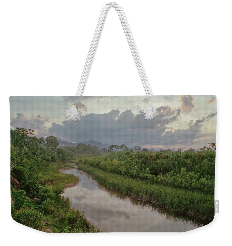 Tropical Rainforest Weekender Tote Bag featuring the photograph Sunset Over An Amazon Jungle River by Linka A Odom