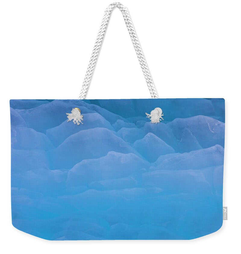 Extreme Terrain Weekender Tote Bag featuring the photograph The Contours Of Ice On The Surface Of by Mint Images - Art Wolfe