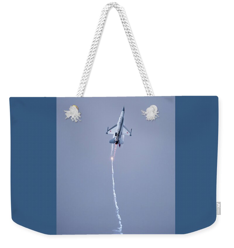 F-16 Fighting Falcon Weekender Tote Bag featuring the photograph The Danish F-16 Fighting Falcon in high speed action dropping flares by Torbjorn Swenelius
